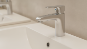 A close-up view of an elegant, modern bathroom faucet designed to resist stains from hard water. The faucet features a sleek, brushed nickel finish, showcasing its shiny, clean lines and minimalist design. In the background, a stylish bathroom sink made of smooth white porcelain reflects soft, natural light, highlighting the faucet's details. Water droplets glisten on the faucet, emphasizing its functionality against hard water stains. Warm, ambient lighting creates a cozy atmosphere, enhancing the luxurious feel of the setting. The angle captures the faucet from a slightly elevated perspective, allowing a clear view of both the spout and the sink, inviting viewers to appreciate the perfect blend of style and practicality in a bathroom setting.